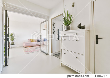 Stylish hallway with door and window to light living room in modern house Stylish hallway with door and window to light living room in modern house 91306213