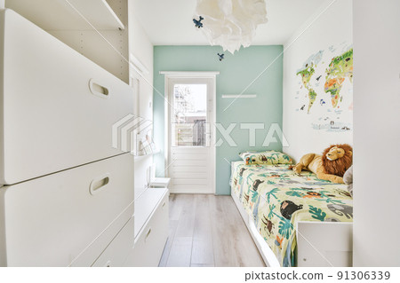 Minimalist interior design of small bedroom with soft bed placed in corner and wooden wardrobe and shelves with lamp illumination 91306339