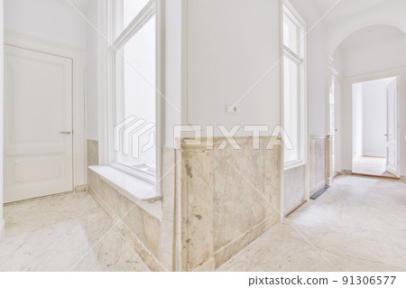 Interior of modern flat in minimal style with narrow empty corridor illuminated by lamps Interior of modern flat in minimal style with narrow empty corridor illuminated by lamps 91306577