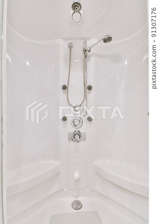 Shower tap and levers installed on white wall in modern spacious bathroom at home Shower tap and levers installed on white wall in modern spacious bathroom at home 91307176