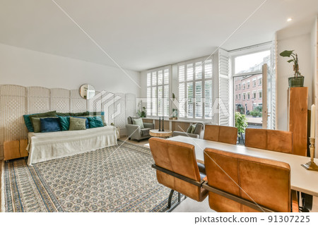 Interior of a living room with carpet on the floor, access to the street and a dining area in a modern house Interior of a living room with carpet on the floor, access to the street and a dining area in a modern house 91307225