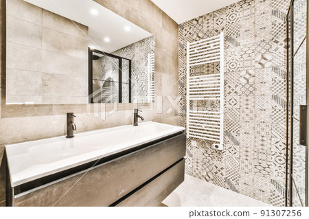 Luxurious bathroom interior with large sink and beige tiles 91307256