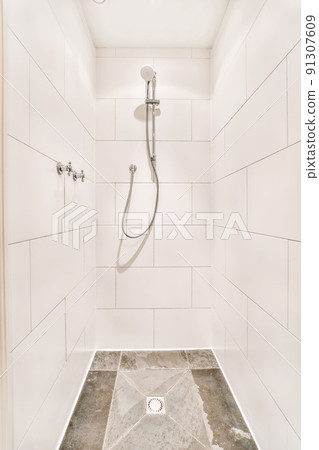 Lovely design of the shower cabin with white tiles and a convenient faucet Lovely design of the shower cabin with white tiles and a convenient faucet 91307609