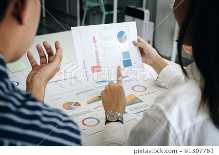 Business adviser analyzing financial figures denoting the progress in the work of the company 91307761