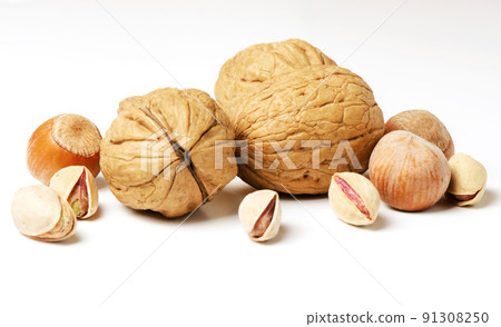 Walnuts, hazelnuts and pistachios on a white background. Nut - a source of vitamins and useful trace elements. For a healthy and vegetarian diet. 91308250