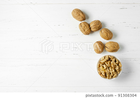 Walnuts on a white background. Nut - a source of vitamins and useful trace elements. Flat top view 91308304