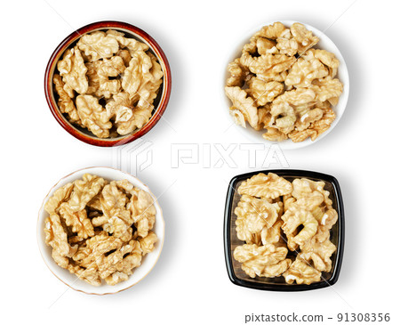 Peeled walnut kernels in a bowl. Isolated on a white background. Set 91308356