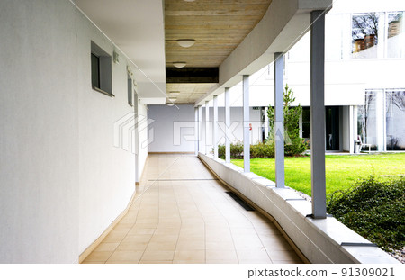 outdoor empty corridor with garden in the modern office building outdoor empty corridor with garden in the modern office building 91309021