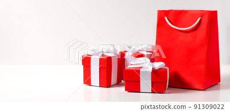 Red gift boxes and a bag on a white background. Copy space. Red gift boxes and a bag on a white background. Copy space. 91309022