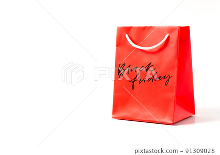 Black Friday - handwritten inscription on a red gift bag. White background. The concept of discounts and sales in retail 91309028