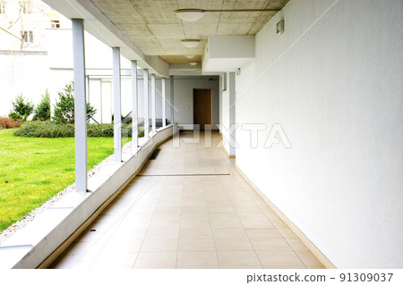 outdoor empty corridor with garden in the modern office building outdoor empty corridor with garden in the modern office building 91309037