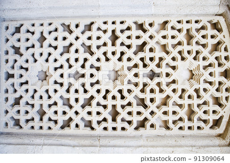 Ancient background with oriental ornaments on the window. Wooden frame on the window, traditional arabic style of architecture Ancient background with oriental ornaments on the window. Wooden frame on the window, traditional arabic style of architecture 91309064