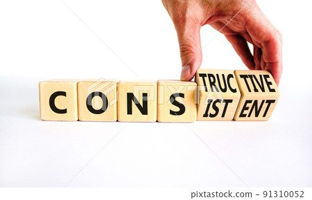 Constructive or consistent symbol. Businessman turns cubes, changes the word consistent to constructive. Beautiful white background, copy space. Business, constructive or consistent concept. Constructive or consistent symbol. Businessman turns cubes, changes the word consistent to constructive. Beautiful white background, copy space. Business, constructive or consistent concept. 91310052