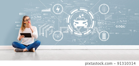 EV concept with young woman using a tablet 91310314