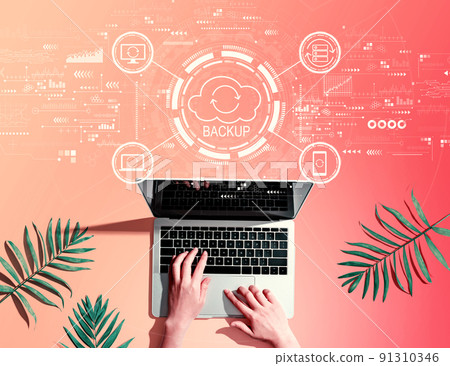 Backup concept with person using a laptop Backup concept with person using a laptop 91310346