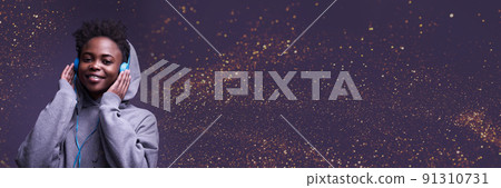 Banner is an African-American woman, wearing headphones. He looks directly into the camera in a sweatshirt against the background of the color of 2022 with sequins. High-quality photography Banner is an African-American woman, wearing headphones. He looks directly into the camera in a sweatshirt against the background of the color of 2022 with sequins. High-quality photography 91310731