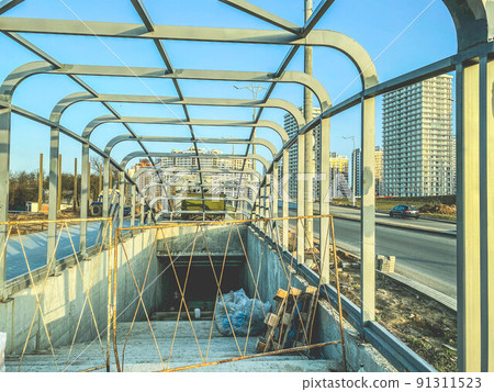 construction of an underpass in the city center. the concrete structure is fenced off from the passage of tourists and residents. crossing without roof and doors 91311523