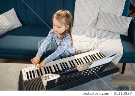 Little cute girl having lesson at piano at school of music. Little cute girl having lesson at piano at school of music. 91313827