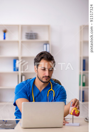 Young male doctor cardiologist working in the clinic 91317324