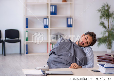 Young male employee in oversleeping concept Young male employee in oversleeping concept 91317432