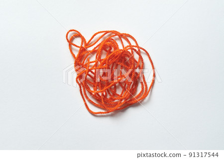 Red tangled thread on white. Red tangled thread on white. 91317544