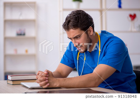Young male doctor working in the clinic Young male doctor working in the clinic 91318048