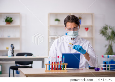 Young male chemist working at the lab 91318069