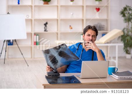 Young male doctor radiologist working in the clinic Young male doctor radiologist working in the clinic 91318123