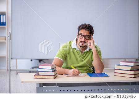 Young male student preparing for exams in the classroom 91318480
