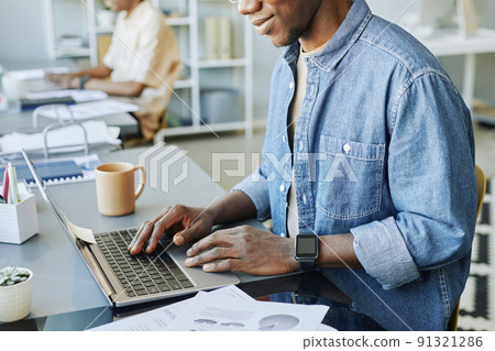Black Man Typing at Laptop Black Man Typing at Laptop 91321286