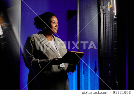 Woman Using Laptop in Server Room 91321908