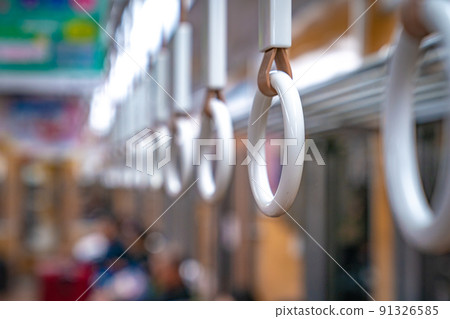 Close up Circle plastic hand holding in the underground train Japan. 91326585