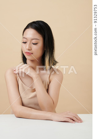 Woman Adjusting Top Strap Woman Adjusting Top Strap 91329753