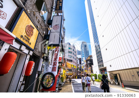 View of Tokyo Mode Gakuen Cocoon Tower in Shinjuku subcenter from Nibangai Street, Tokyo cityscape of Japan 91330063
