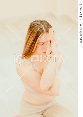 Young sporty woman, fitness instructor in sportswear doing stretching and pilates on yoga mat in the studio with mirror. Female fitness yoga routine concept. Healthy lifestyle and harmony. Young sporty woman, fitness instructor in sportswear doing stretching and pilates on yoga mat in the studio with mirror. Female fitness yoga routine concept. Healthy lifestyle and harmony. 91332621