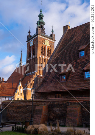 Gothic Church of St. Catherine in Gdansk Ancient architecture of old town in Gdansk Poland. Beautiful and colorful old houses historical part of downtown Gothic Church of St. Catherine in Gdansk Ancient architecture of old town in Gdansk Poland. Beautiful and colorful old houses historical part of downtown 91333202