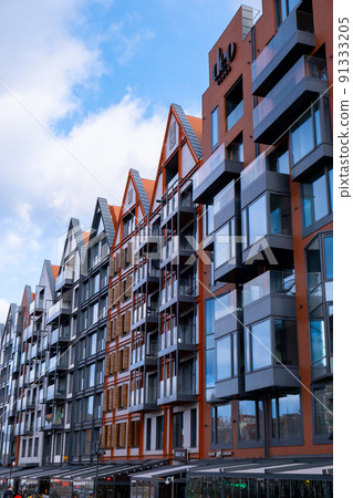 Modern buildings on Granary Island over the Motlawa River in Old Town. Abstract structure. Creative photo Tourism on the Motlawa River. New Apartments architecture glass windows with reflections Modern buildings on Granary Island over the Motlawa River in Old Town. Abstract structure. Creative photo Tourism on the Motlawa River. New Apartments architecture glass windows with reflections 91333205