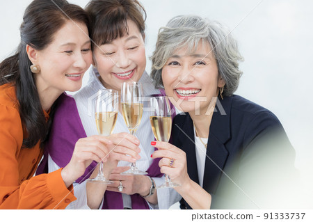 Senior woman toasting with champagne Senior woman toasting with champagne 91333737