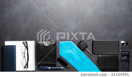 Men's accessories on a black concrete background. The concept of a successful modern man. Copy space 91334405