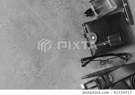 Men's accessories on a black concrete background. The concept of a successful modern man. Copy space 91334413