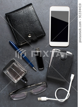 Men's accessories on a black concrete background. The concept of a successful modern man 91334419