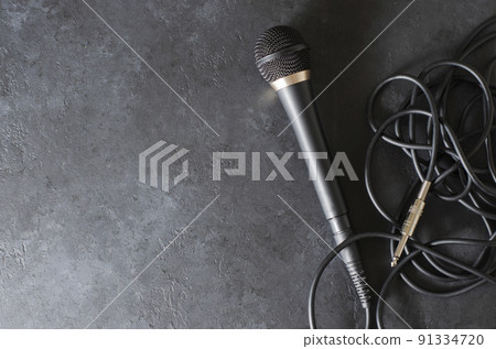 Black microphone on a dark concrete background. Equipment for vocals or interviews or reporting. Copy space Black microphone on a dark concrete background. Equipment for vocals or interviews or reporting. Copy space 91334720