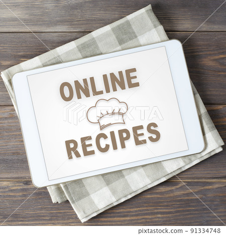Online recipes. App in smartphone. Brown wooden background. Online recipes. App in smartphone. Brown wooden background. 91334748