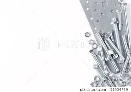 Repair tool. Bolts and metal mounting plates. White background. Copy space Repair tool. Bolts and metal mounting plates. White background. Copy space 91334759
