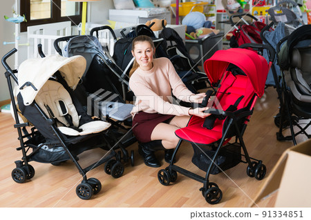Ordinary mother buyer choosing stroller cane 91334851