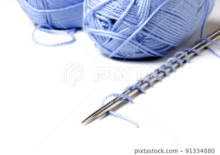 Balls of blue yarn and knitting needles. White background. Copy space. The concept of women 's needlework 91334880