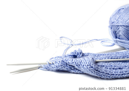 Balls of blue yarn and knitting needles. White background. Copy space. The concept of women 's needlework 91334881