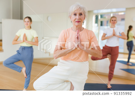 Senior woman exercising stretching workout Senior woman exercising stretching workout 91335992