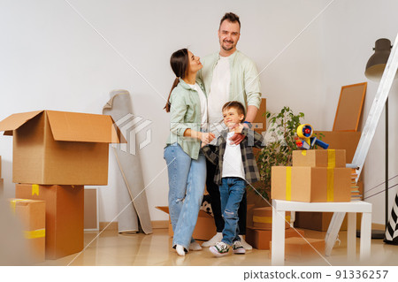 Young parents and son having fun during moving day to new house 91336257