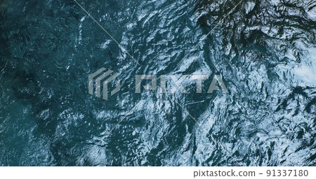 Close-up, turquoise fresh water of mountain river, top view. Beautiful crystal clear water of lake nature, moving, reflecting. Pure blue mountains glacier water. Natural ripples on emerald cold river 91337180